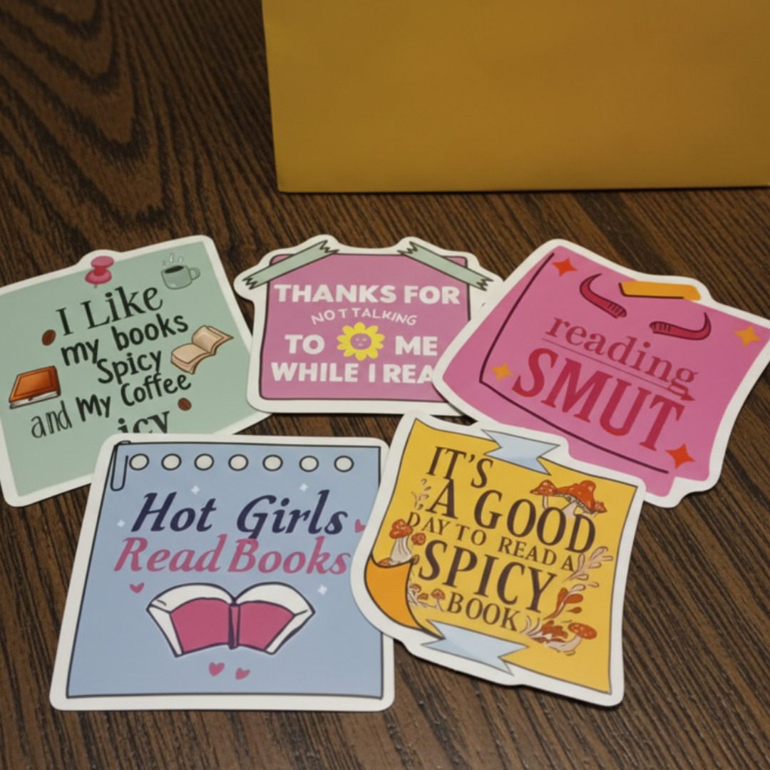 Five colorful stickers with humorous text on a red surface