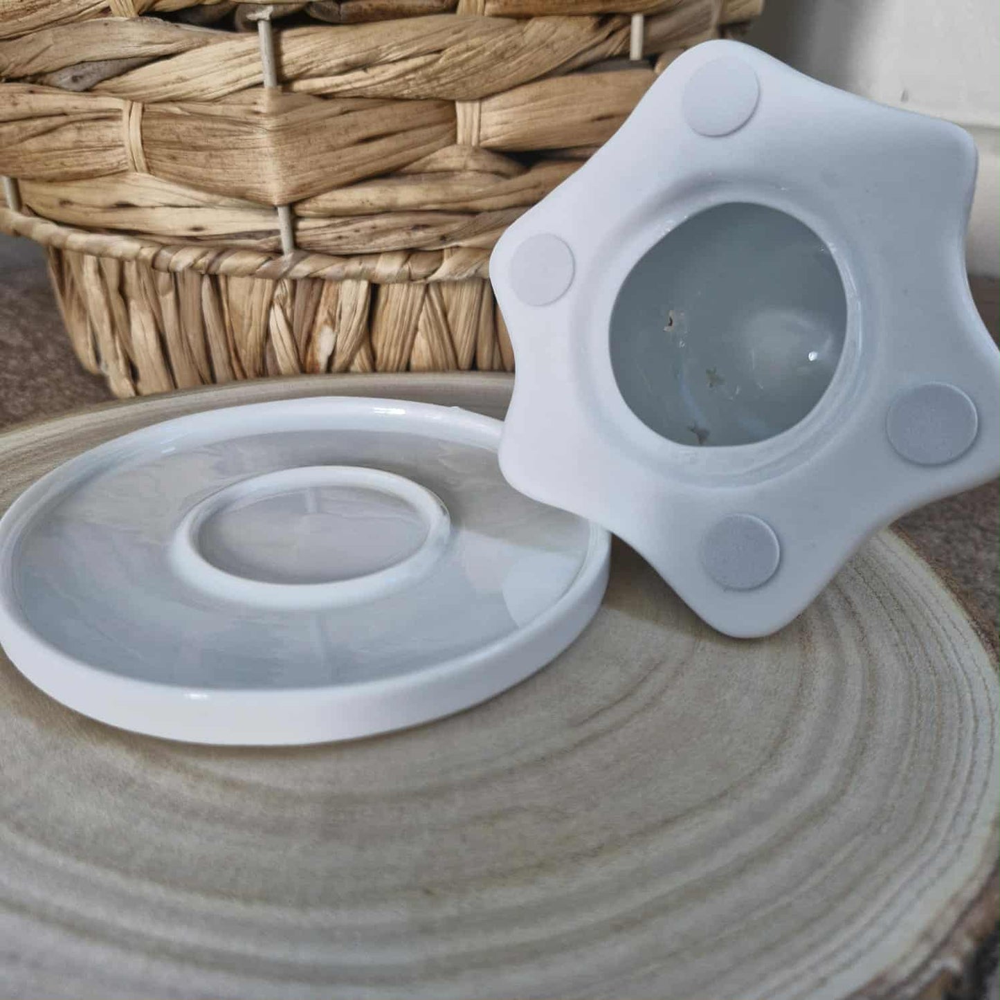 Silicone lid on a ceramic surface with a woven basket in the background