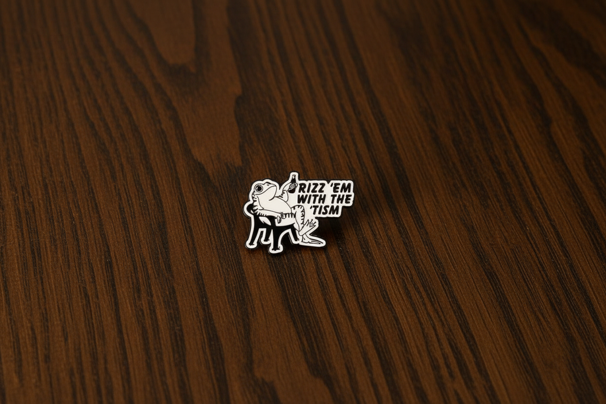 An enamel Pin badge that has a picture of a frog sitting in a chair, holding a bottle saying Rizz 'em with the 'tism on a dark oak table