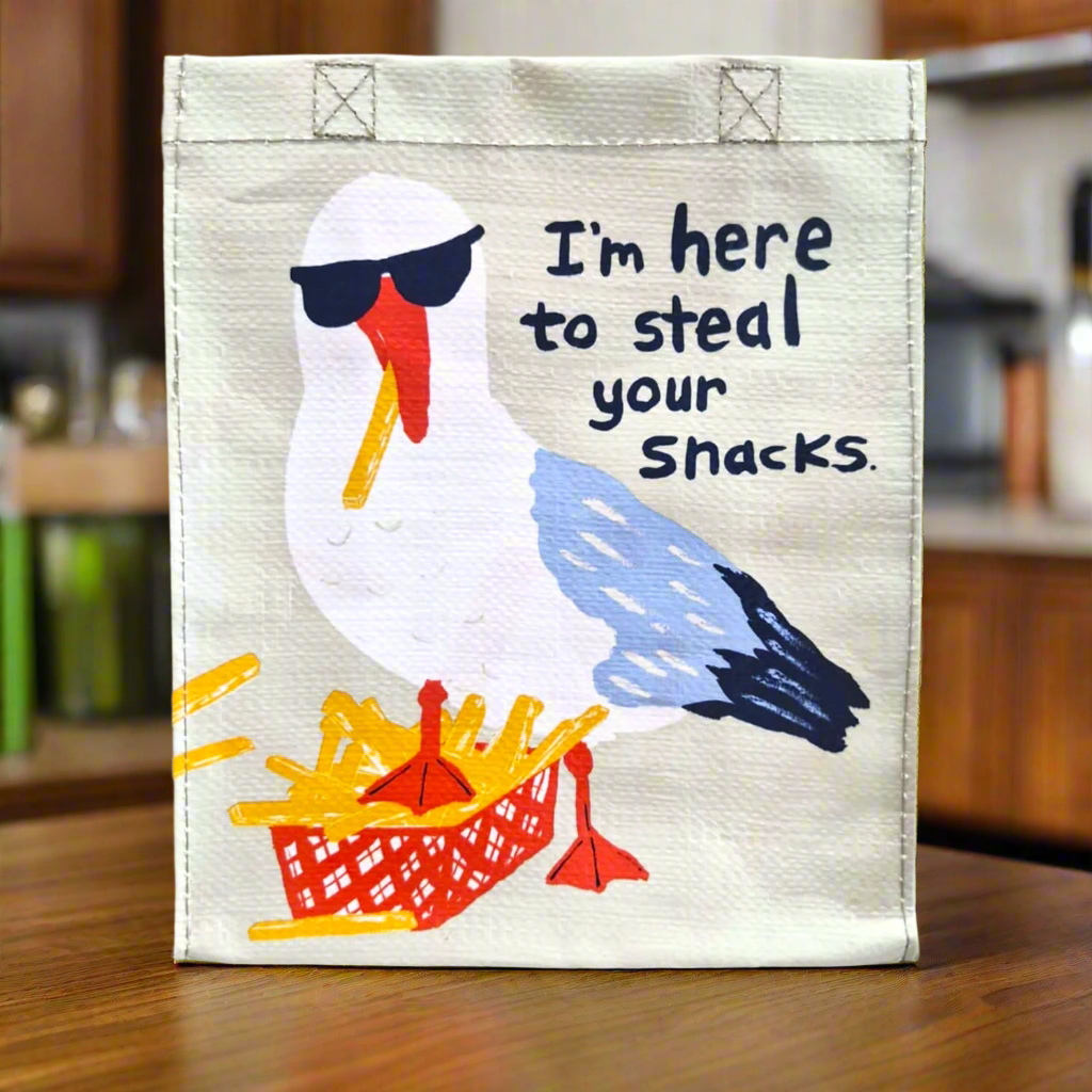 This is our Seagull Stealing Snacks Lunch Bag which has a picture of a seagull eating a basket of chips with the phrase I'm here to steal your snacks.
