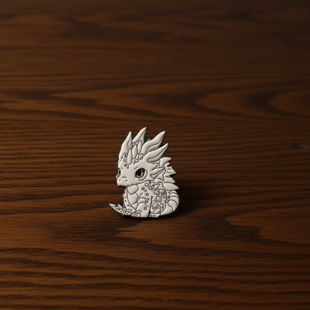Silver dragon-shaped pin on a dark oak table
