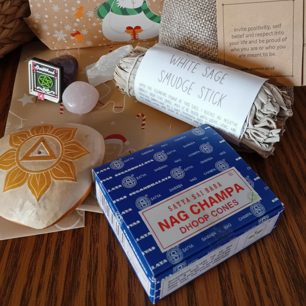 Box of Satya Sai Baba Nag Champa Dhoop Cones with white sage smudge stick on a red surface, which is a part of the witchy advent calendar