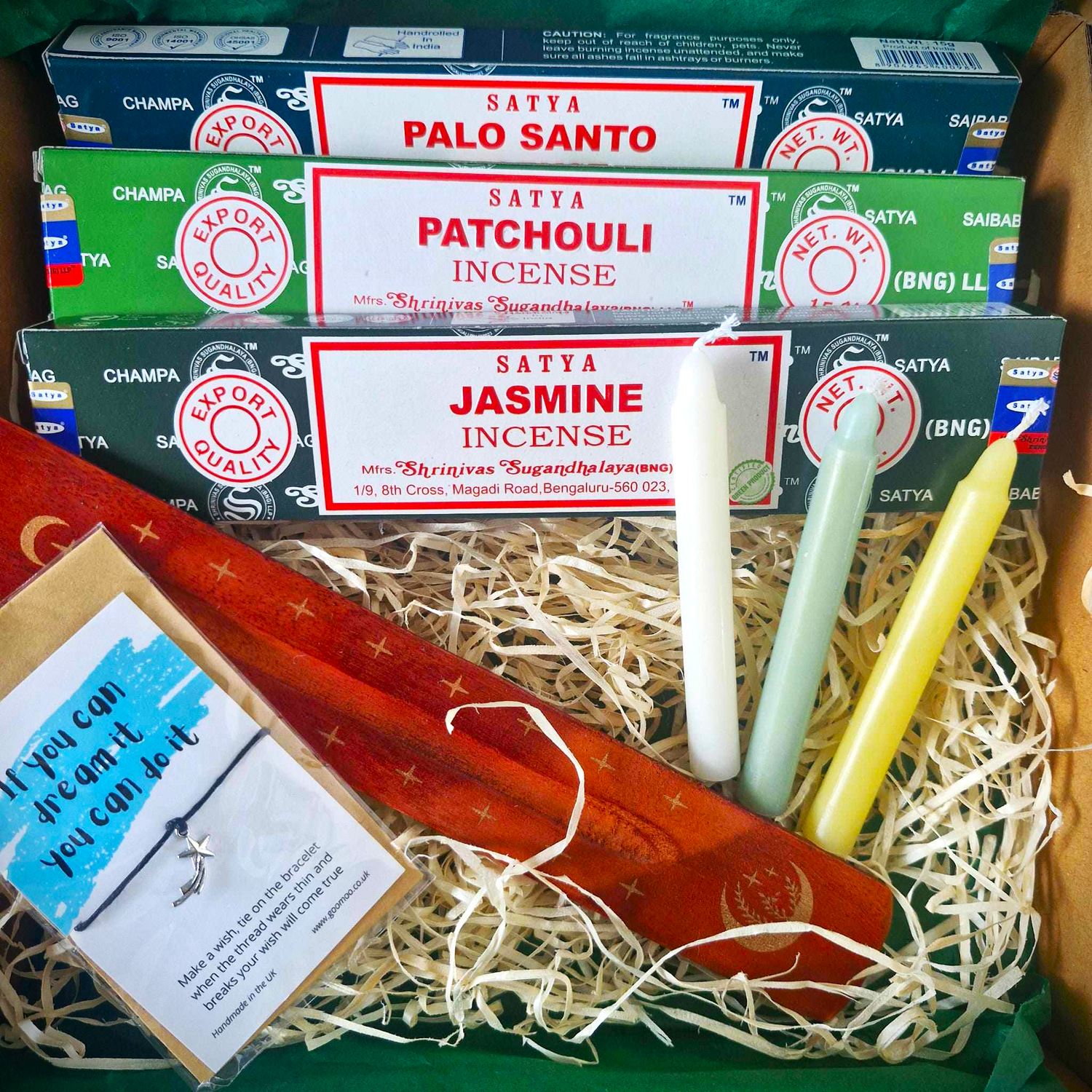 A selection of Incense with an Ash Catcher, 3 Spell Candles and a wish bracelet.