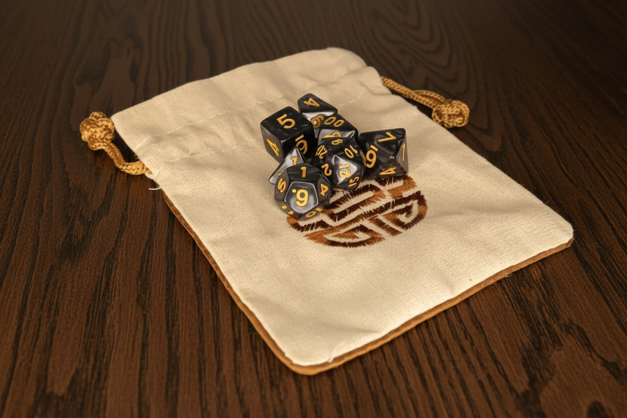 Set of dice with blue and gold design on a beige drawstring bag against a dark oak table