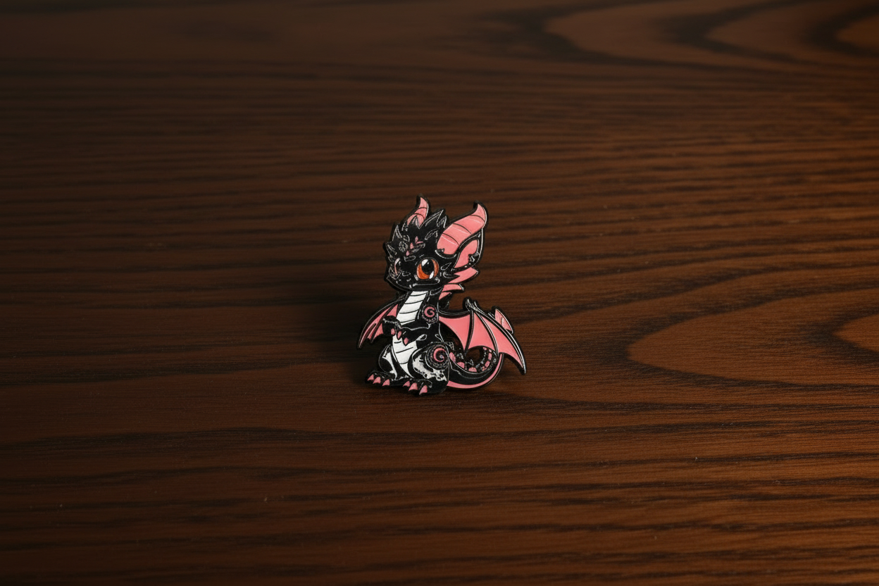 Decorative black dragon pin badge on a dark oak table