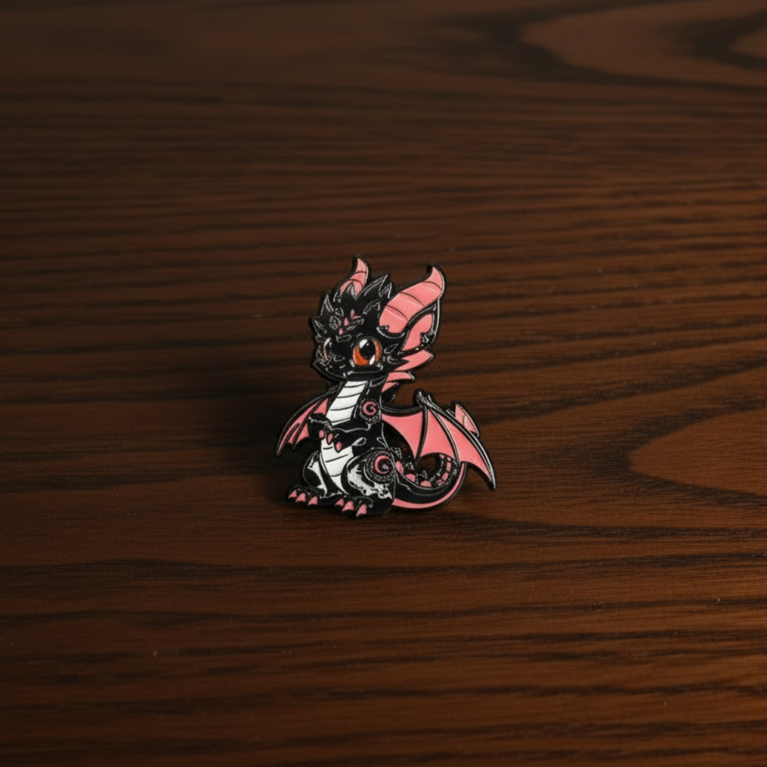 Decorative black dragon pin badge on a dark oak table