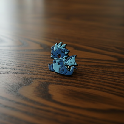 Decorative blue dragon pin badge on a black surface