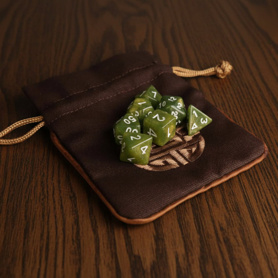 Green dice set in a brown Dungeons and Dragons drawstring dice pouch on a dark surface