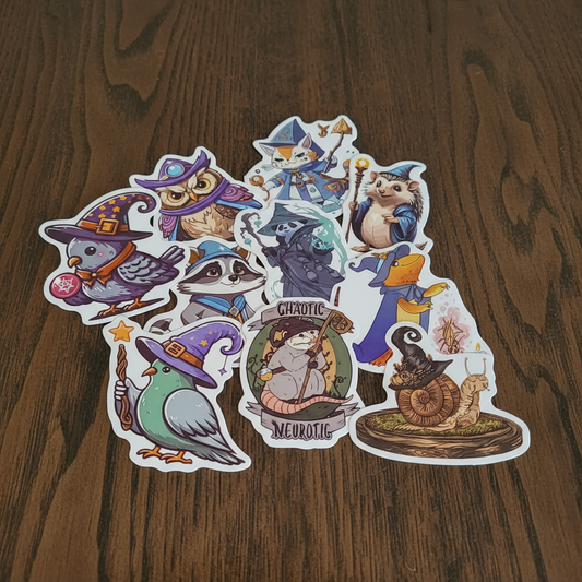 Set of colorful stickers with cute witchy animal cartoon characters on a dark oak table