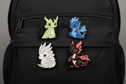 Four dragon-shaped pins on a black background