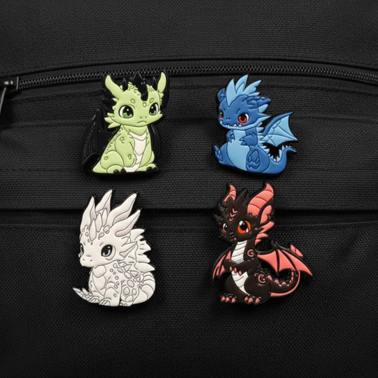 Four dragon-shaped pins on a black background