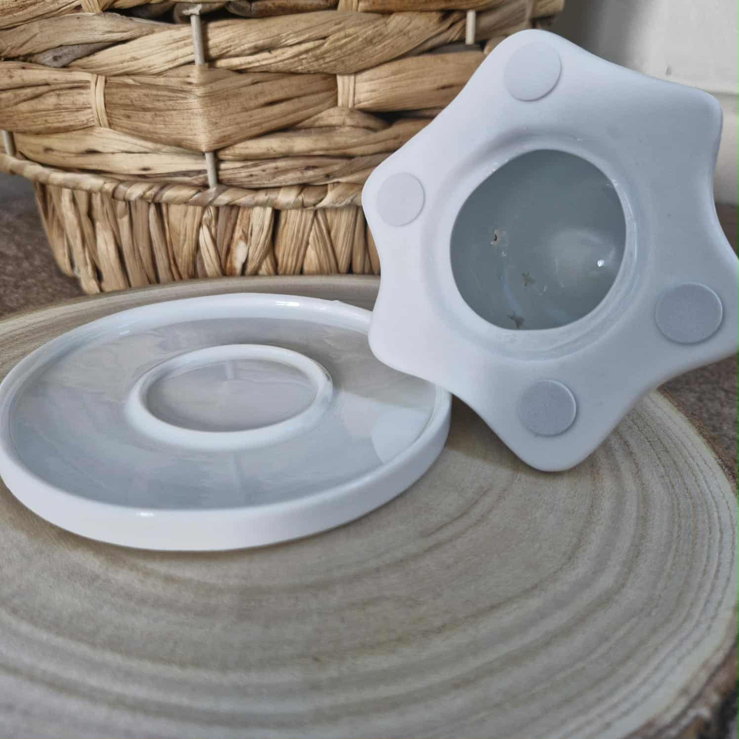 Silicone lid on a ceramic surface with a woven basket in the background