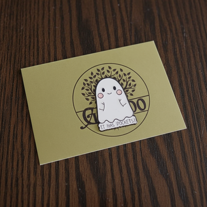 Cartoon ghost with pockets on a cardboard box with a brand logo.