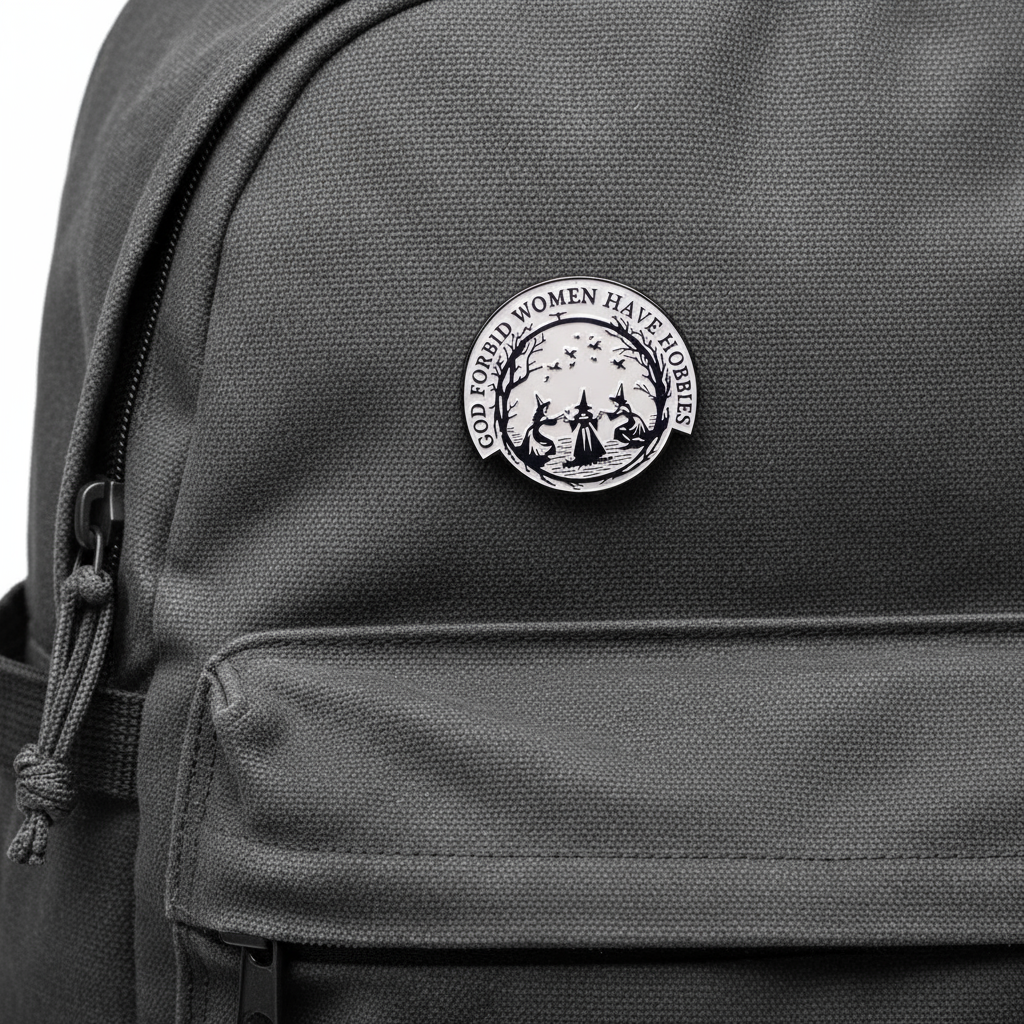 Circular design with three women in hats and text 'GOD FORBID WOMEN HAVE HOBBIES' on a black backpack