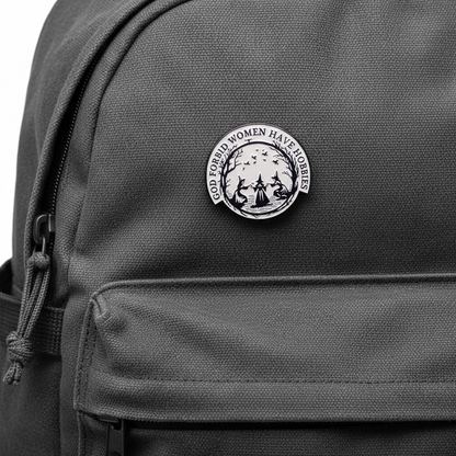 Circular design with three women in hats and text 'GOD FORBID WOMEN HAVE HOBBIES' on a black backpack