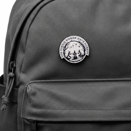 Circular design with three women in hats and text 'GOD FORBID WOMEN HAVE HOBBIES' on a black backpack