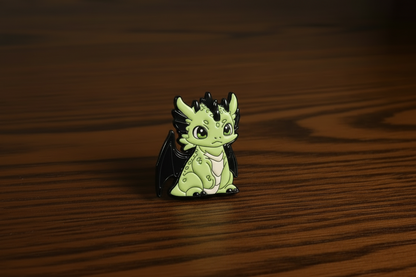 Green dragon pin on a dark oak table