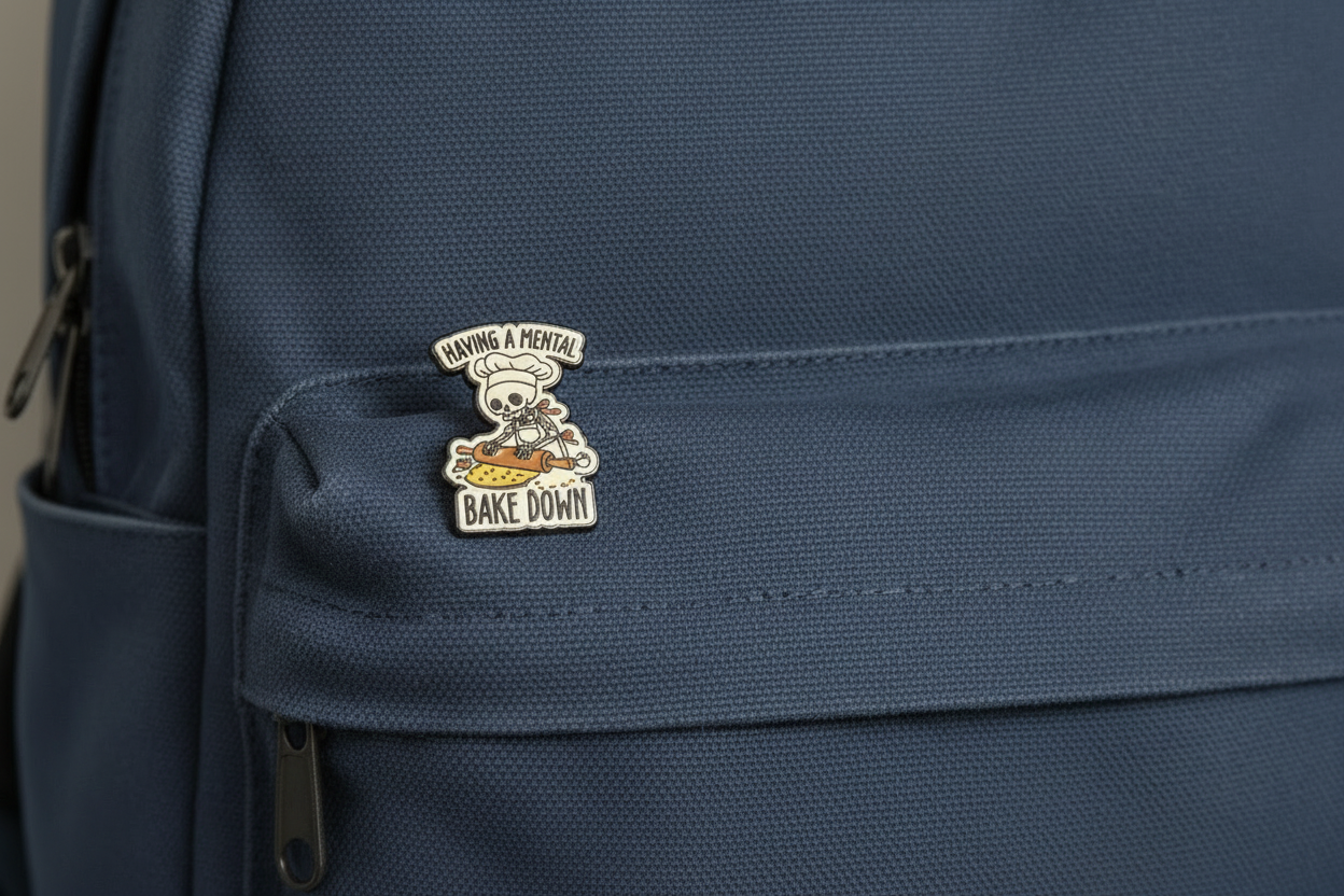 Pin Badge with a skull chef design on saying having a mental back down on a backpack