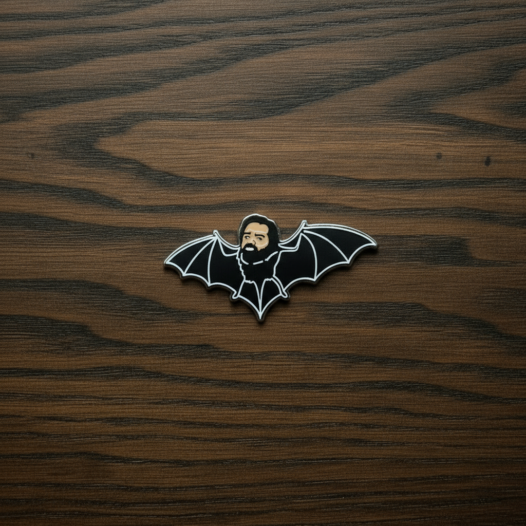 A close up of a Pin Badge of Laszlo on a green Goomoo card with and a black background