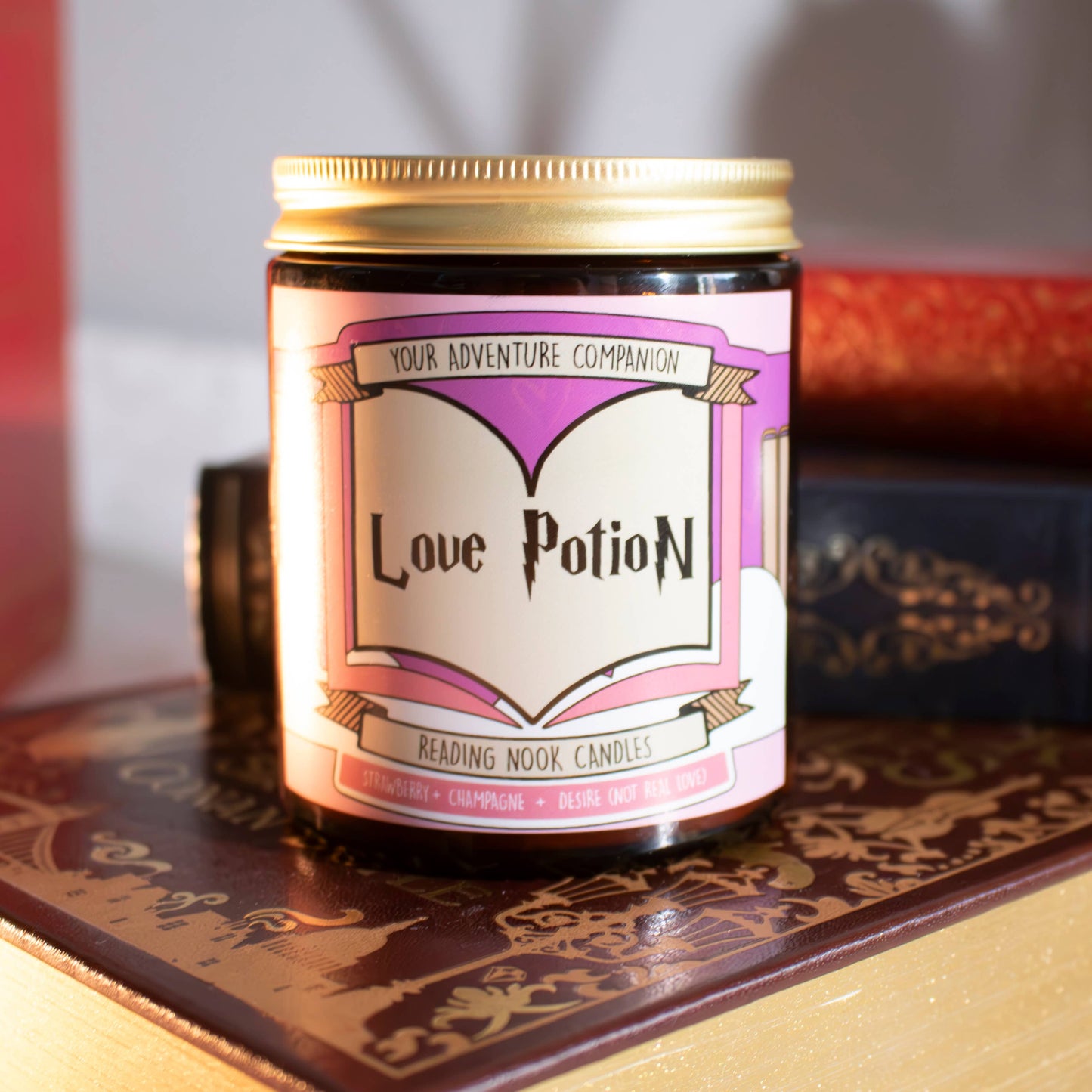 Candle labeled 'Love Potion' with decorative text on a patterned surface