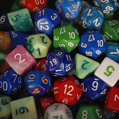 Assorted multicolored dice with numbers on a dark background