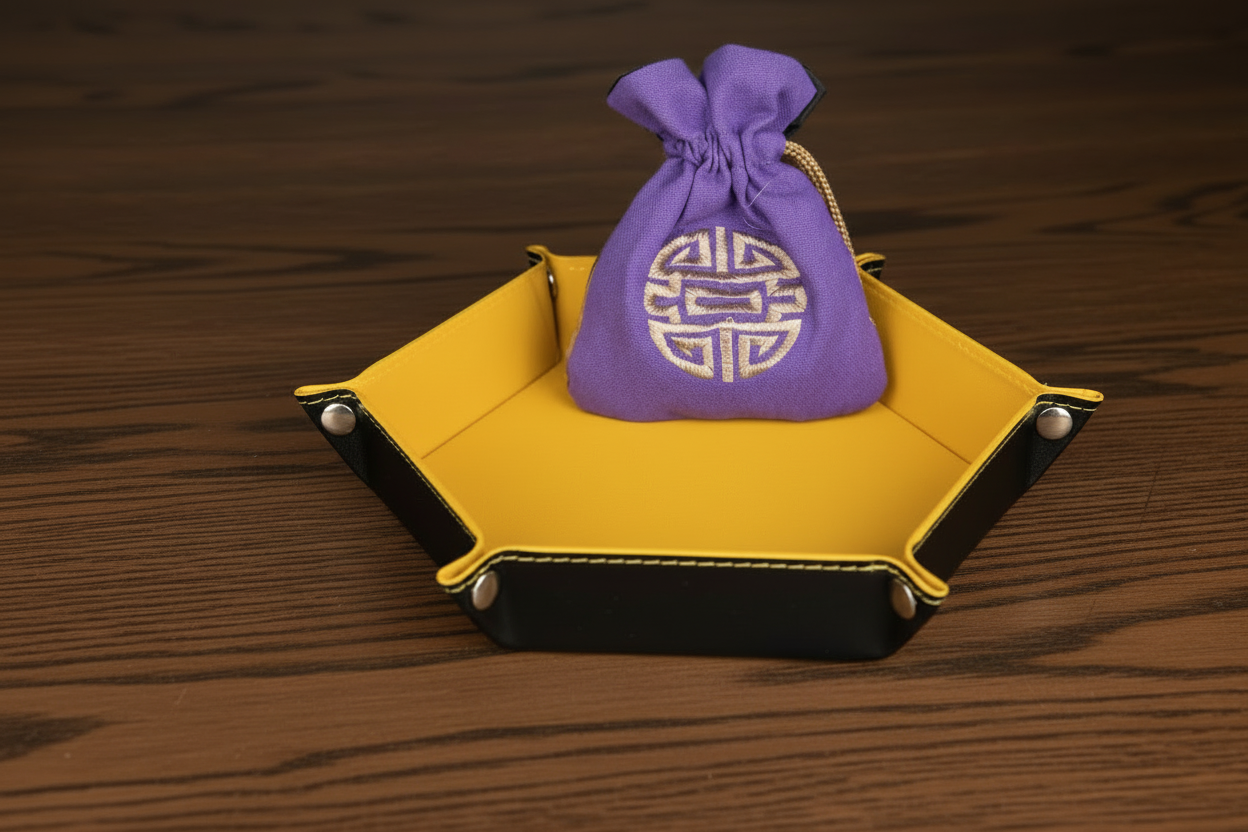 Purple drawstring bag with gold emblem on a yellow surface