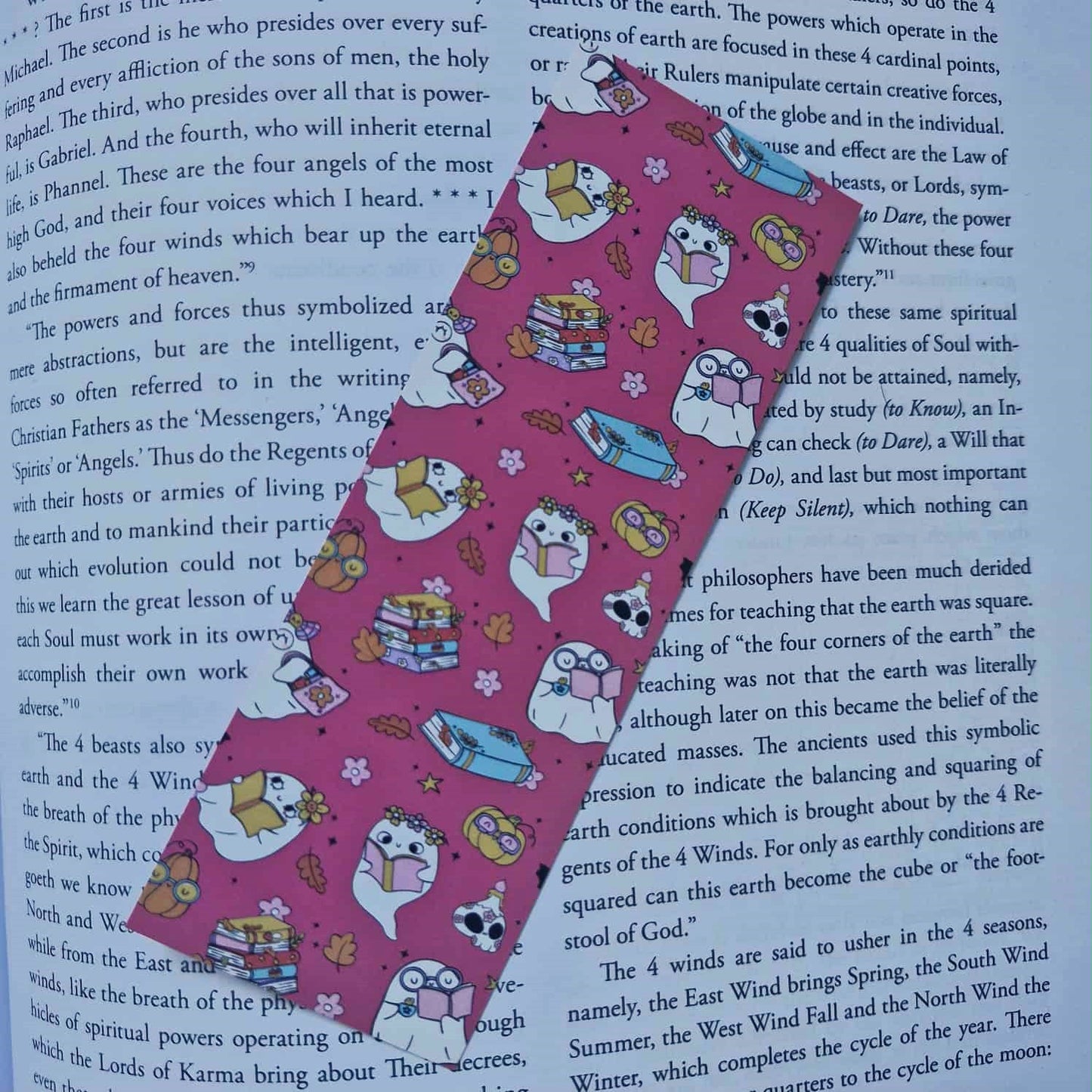 Pink ribbon with cartoon designs on a book page