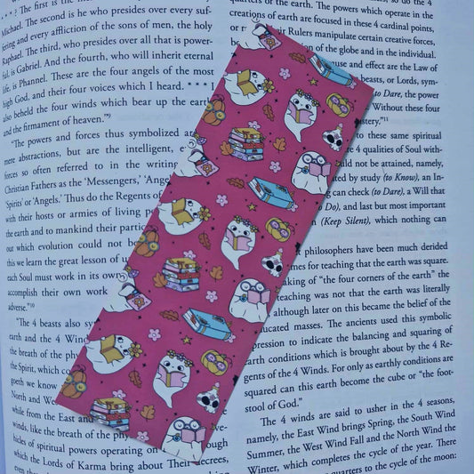Pink ribbon with cartoon designs on a book page