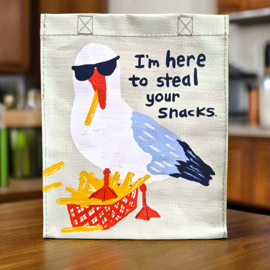 This is our Seagull Stealing Snacks Lunch Bag which has a picture of a seagull eating a basket of chips with the phrase I'm here to steal your snacks.