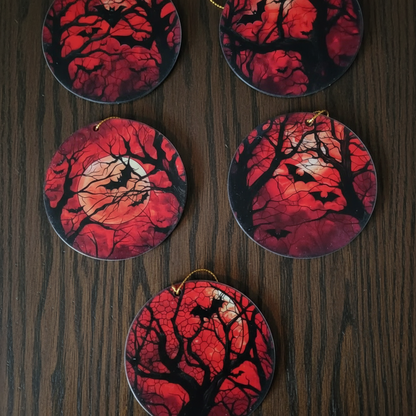 A selection of 5 different spooky hanging decorations, with red backgrounds, the moon, bat and tree silouhettes. Perfect for day to day decor and christmas decor