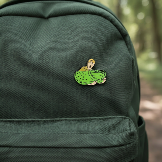 Enamel Pin of Steve Irwin Holding a Croc Shoe on a green backpack
