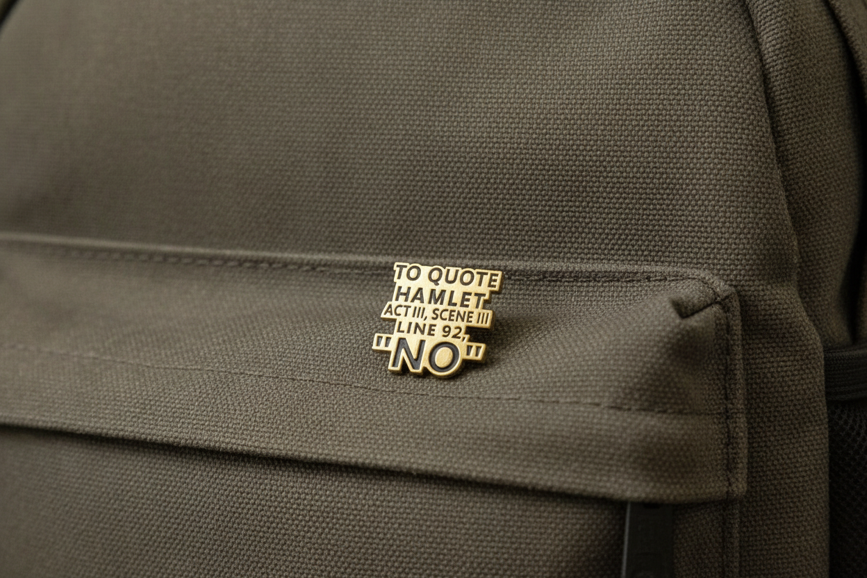 An enamel Pin badge that says to quote Hamlet Act III, Scene III, Line 92, "NO". on a green Backpack.