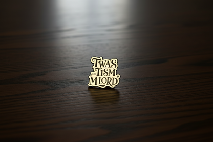 An enamel Pin badge that says TWAS THE TISM, M'LORD. In black writing on a dark oak table