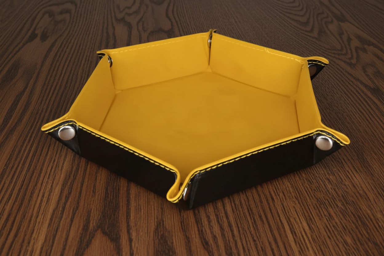 Yellow leather and velvet dice tray on a dark oak table